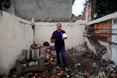 A woman stands in the remains of her home in after an earthquake struck in Tepalcingo, Mexico.