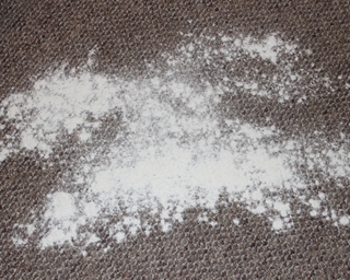 Flour on a dark carpet