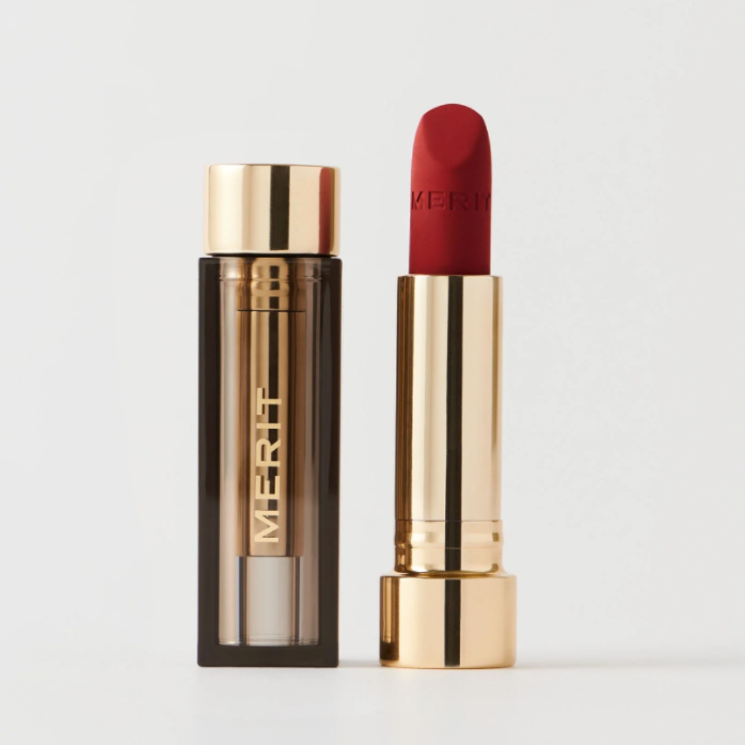 A product shot of the Merit Signature Lip shade Power, on a grey background