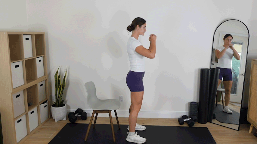 Trainer Kirra Mitlo performing a chair squat with a hold at the top