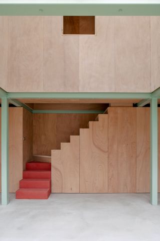 plywood stairs with pale green structural beams