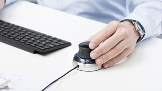 person using SpaceMouse on desk