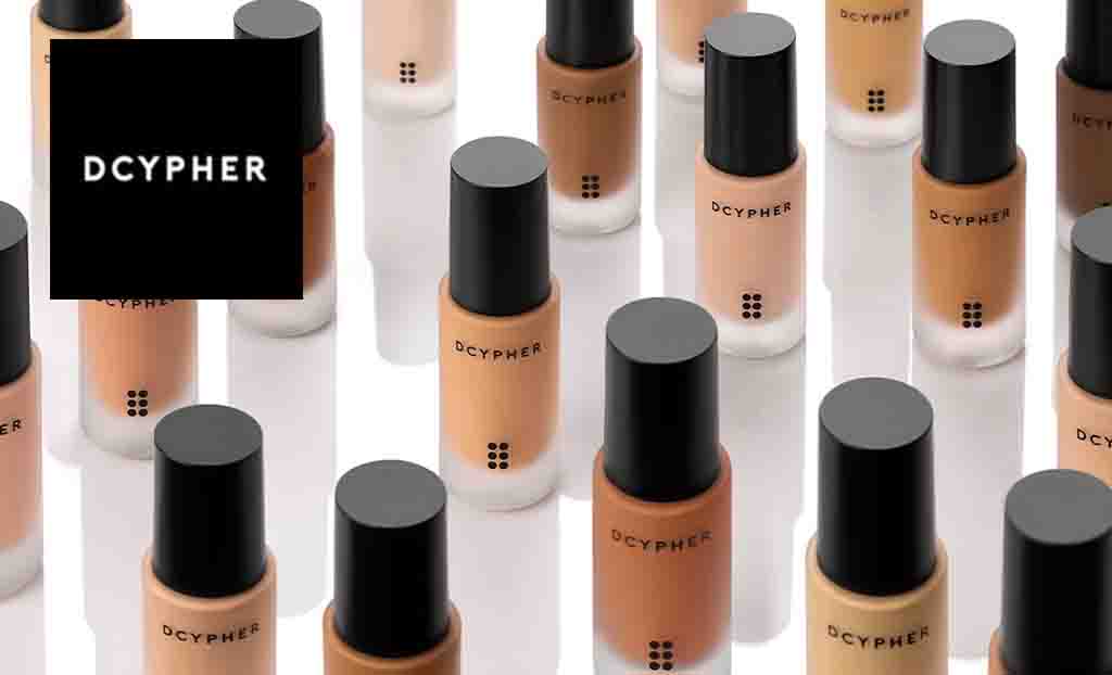 Dcypher logo placed over a collection of foundations ranging from light to dark in shades