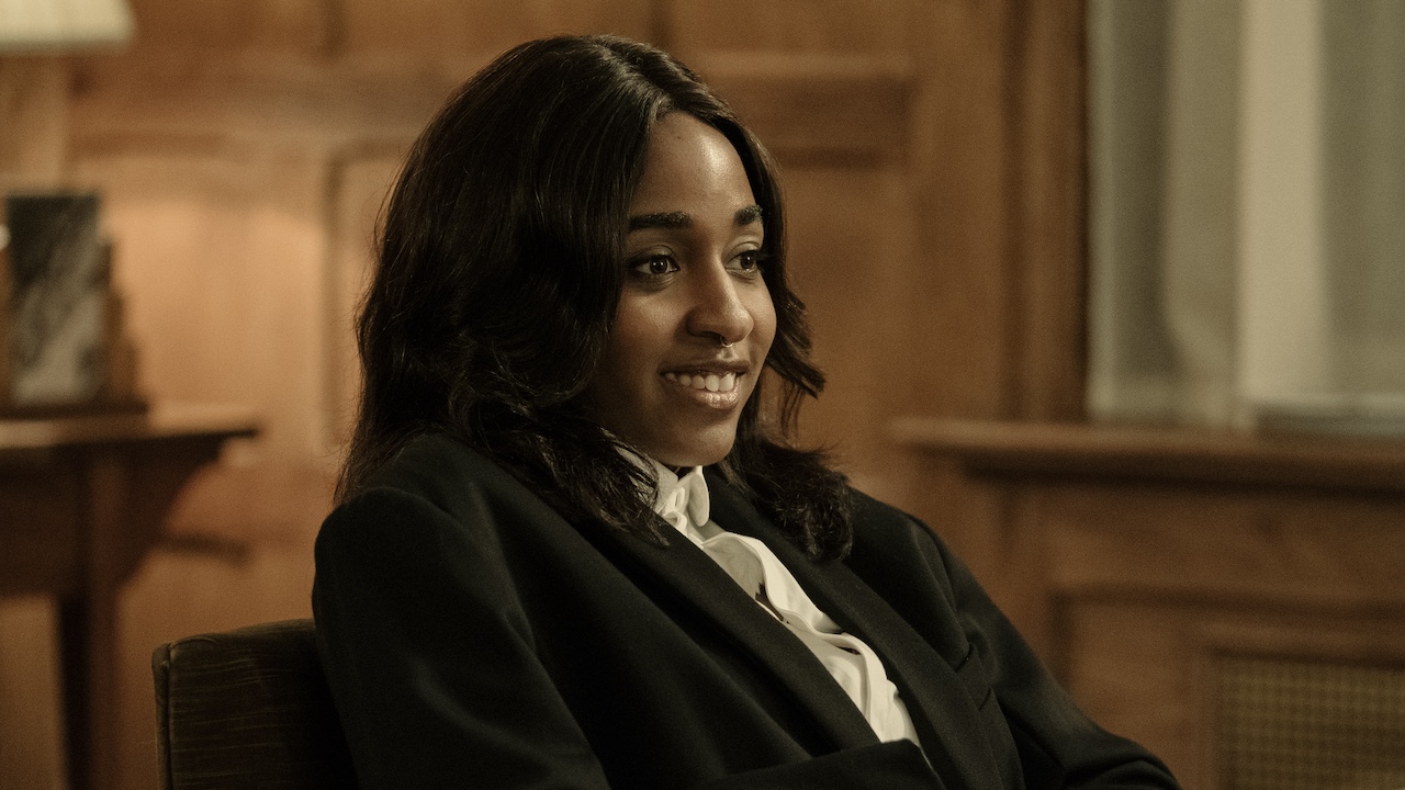 Ayo Edebiri in suit sitting in an office in After The Hunt