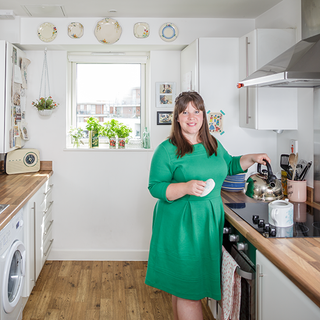 kitchen room with white wall lady wearing green dress