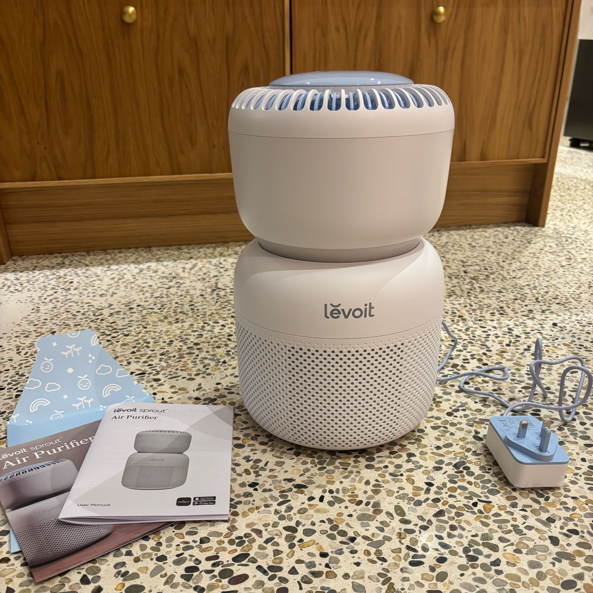 levoit sprout air purifier on a concrete floor