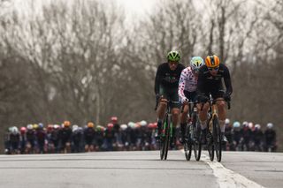 Caja Rural-Seguros RGA's Spanish rider Samuel Fernandez Garcia (Centre L), TotalEnergies' French rider Alexandre Delettre and Uno-X Mobility's Norwegian rider Jonas Abrahamsen cycle in a breakaway with the pack of riders in the background during the 2nd stage of the Paris-Nice cycling race, 183,9 km between Montesson and Bellegarde, on March 10, 2025. (Photo by Anne-Christine POUJOULAT / AFP)