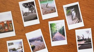 Instax Mini prints laid out on a wooden table