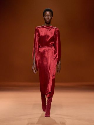 Woman on runway in Hermès pleated dress