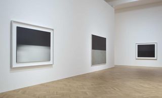 Art exhibition space with white walls displaying 3 black and white abstract paintings