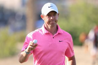 McIlroy walks off the green and waves his golf ball