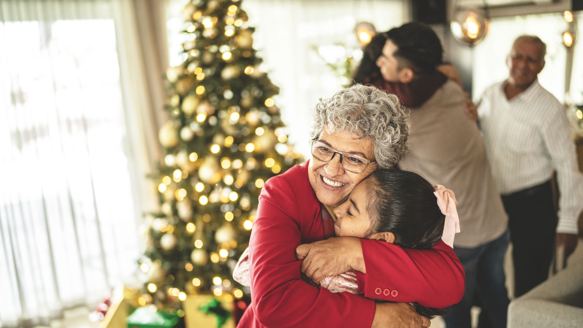 Grandmother hugging granddaughter during Christmas