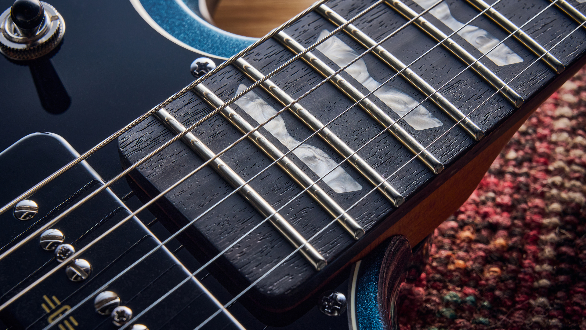 Close up of the fretboard on the Baum Carve electric guitar
