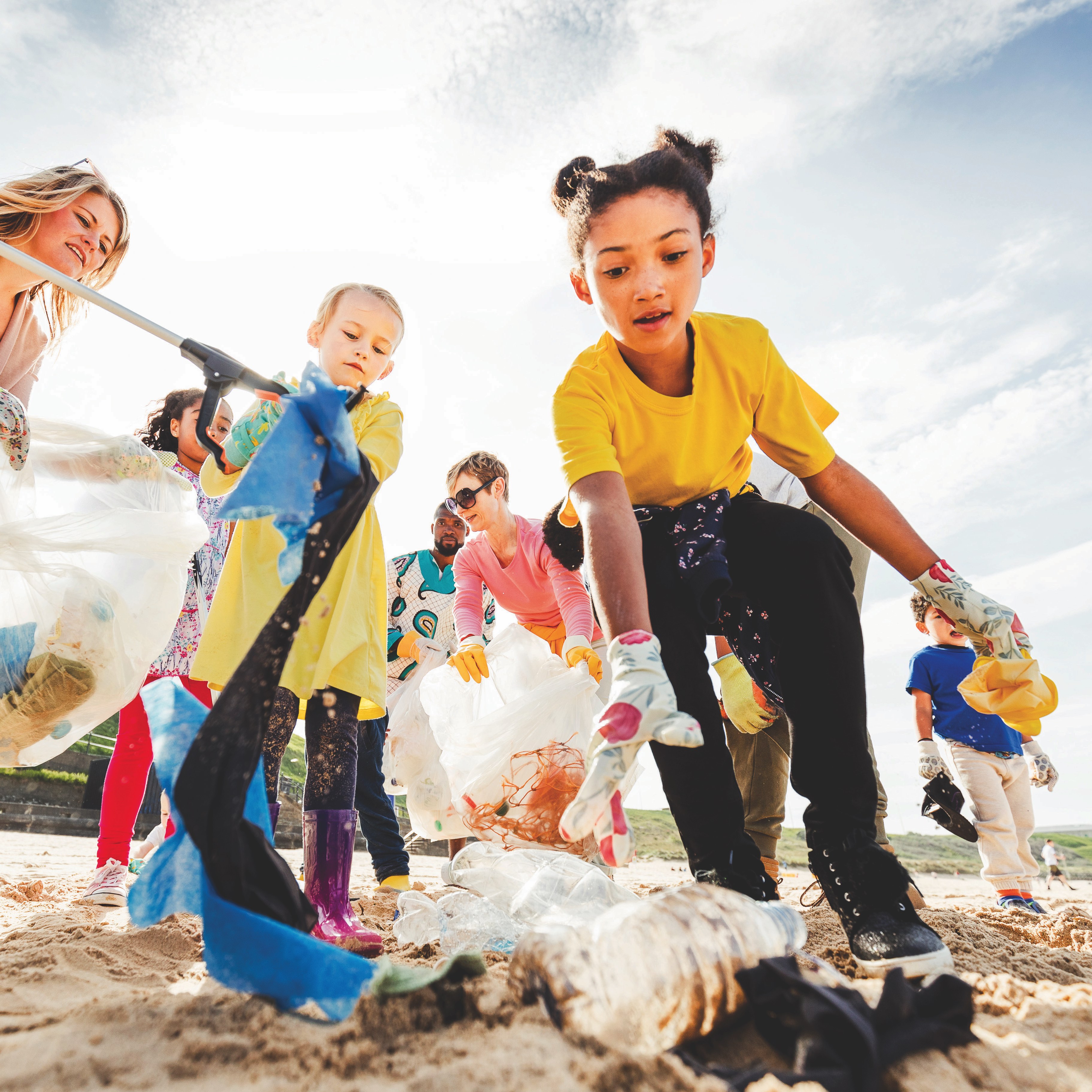 Children picking up litter. atthe beach