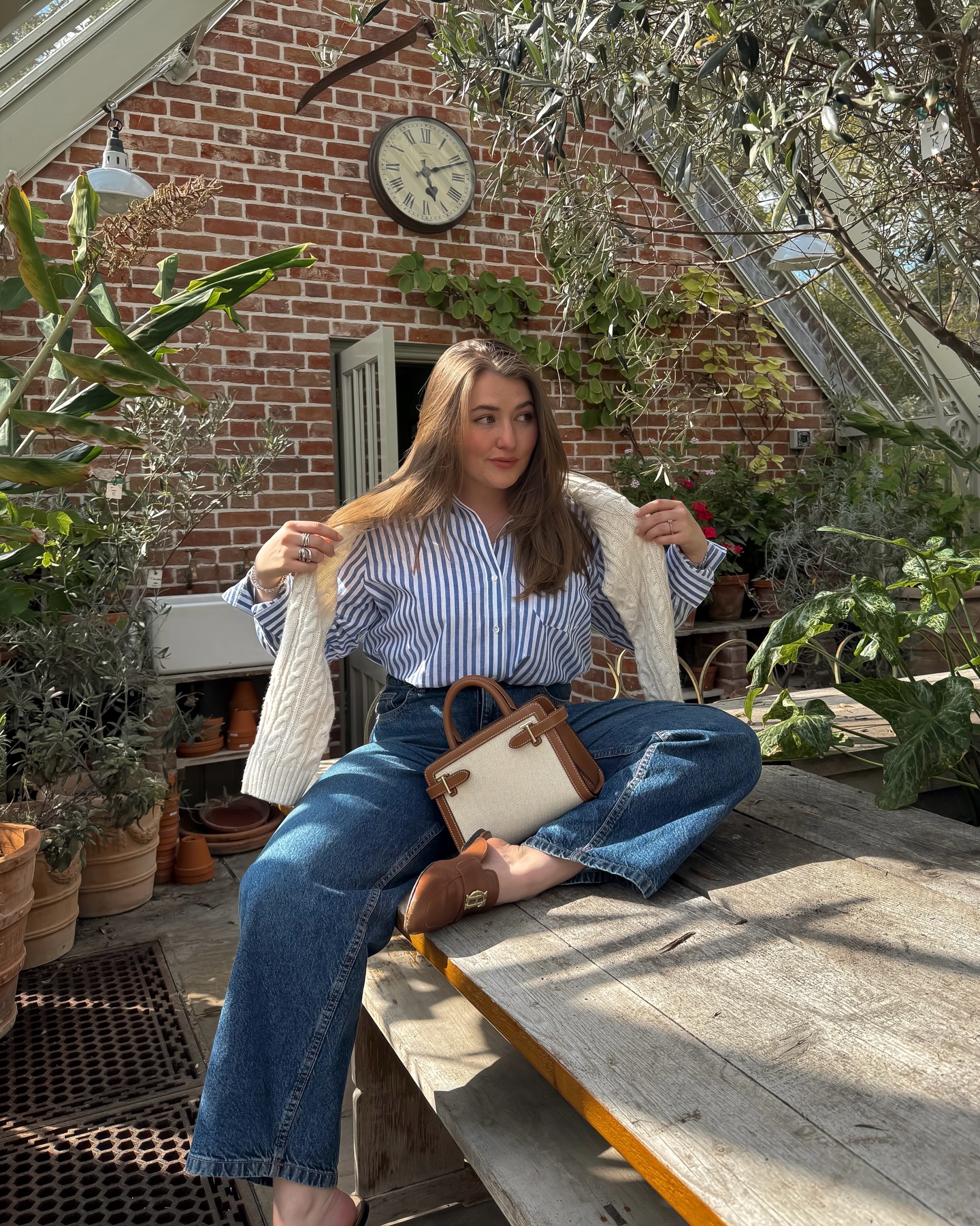 petite elliee wears a striped shirt, straight leg jeans and closed toe mules