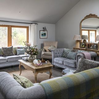 attic living room with sofa set with mirror
