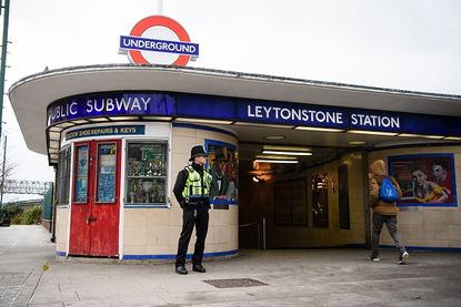 A police officer stands outside the London Tube station Dec. 6, one day after three people were stabbed in what is being investigated as a "terrorist incident"
