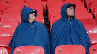 England fans prepared for rain ahead of the Three Lions' friendly against Australia at Wembley in October 2013.
