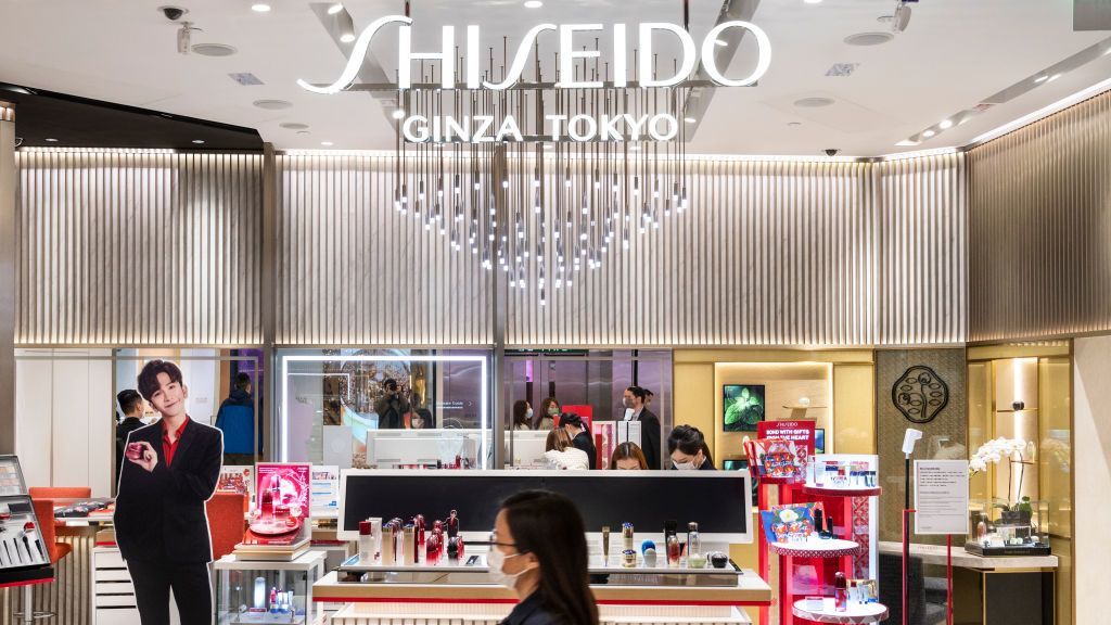 Shoppers walk past Japanese multinational personal care company Shiseido store seen in Hong Kong