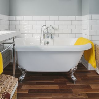 bathroom with wooden floor and bathtub