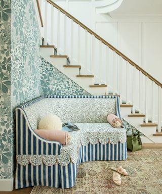 Entryway with wallpaper and skirted bench seating