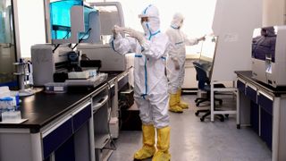 Lab technicians test samples from people suspected of having the COVID-19 coronavirus at a laboratory in Shenyang in China's northeastern Liaoning province on Feb. 12, 2020.