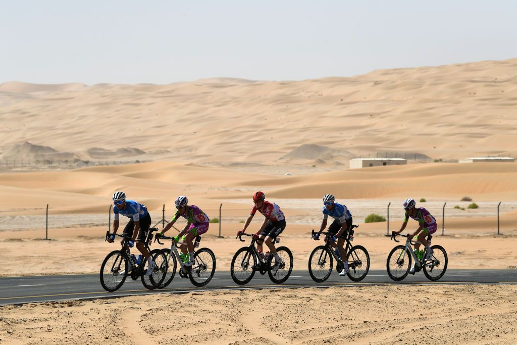 MADINAT ZAYED UNITED ARAB EMIRATES FEBRUARY 20 A general view of Pavel Kochetkov of Russia and Team Gazprom Rusvelo Xandres Vervloesem of Belgium and Team Lotto Soudal Dmitrii Strakhov of Russia and Team Gazprom Rusvelo Luca Rastelli of Italy and Team Bardiani Csf Faizane Alessandro Tonelli of Italy and Team Bardiani Csf Faizane in the breakaway passing through the desert during the 4th UAE Tour 2022 Stage 1 a 184km stage from Madinat Zayed to Madinat Zayed UAETour WorldTour on February 20 2022 in Madinat Zayed United Arab Emirates Photo by Tim de WaeleGetty Images