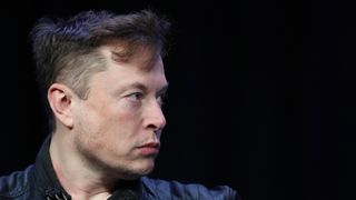 elon musk side profile looking to the right on a black background