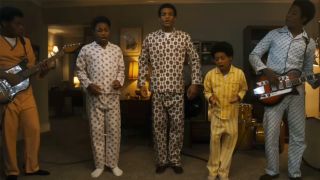 The cast of Michael, playing the Jackson 5 in their pajamas in a living room