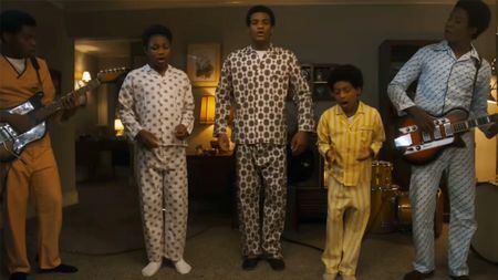 The cast of Michael, playing the Jackson 5 in their pajamas in a living room
