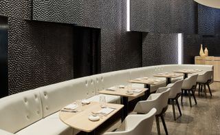 One Aldwych London, UK dinning space with white chairs and wooden flooring