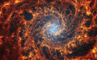 The spiral arms of NGC 628 is 32 million light-years away in the constellation Pisces lead to splashes of gas and dust.