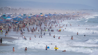 Crowds of people at a beach in California
