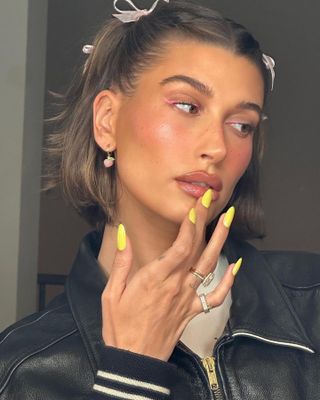 Hailey Bieber with butter yellow long almond shaped nails