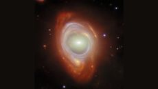 A photo of an orange and purple glowing ring in outer space