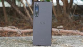 A Sony Xperia 1 IV from the back, with trees in the background