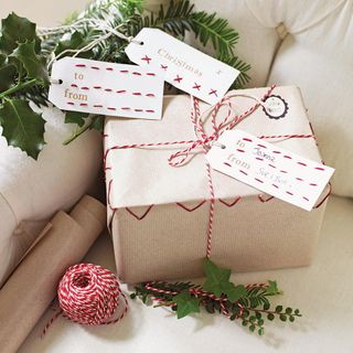 white giftbox with nameplate wrapped with red and white rope