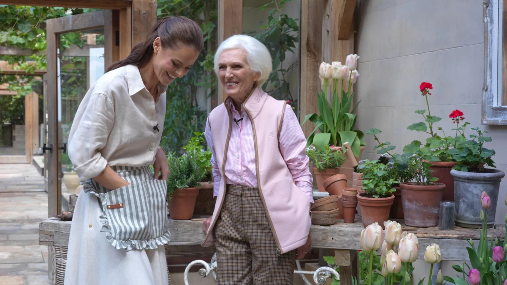 Mary Berry with the founder of Holland Cooper in a potting shed, showing off their new collection