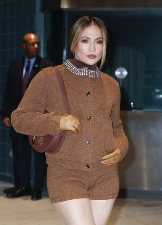 Jennifer Lopez is seen in Chelsea on November 03, 2024 in New York City wearing a caramel cardigan set and knee-high boots for Unstoppable screening and Q&A.