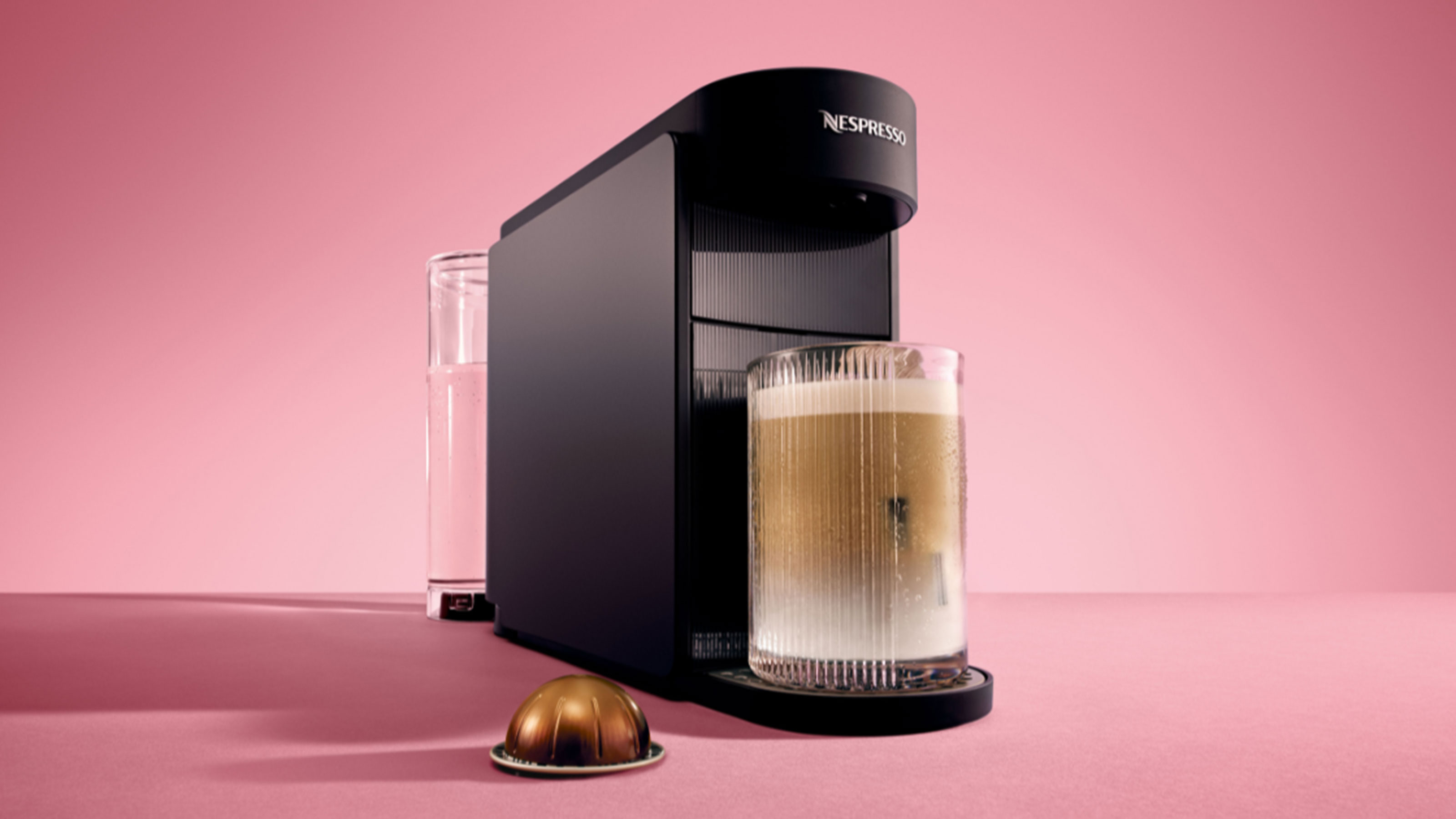 Black Nespresso Vertuo Up machine on pink background