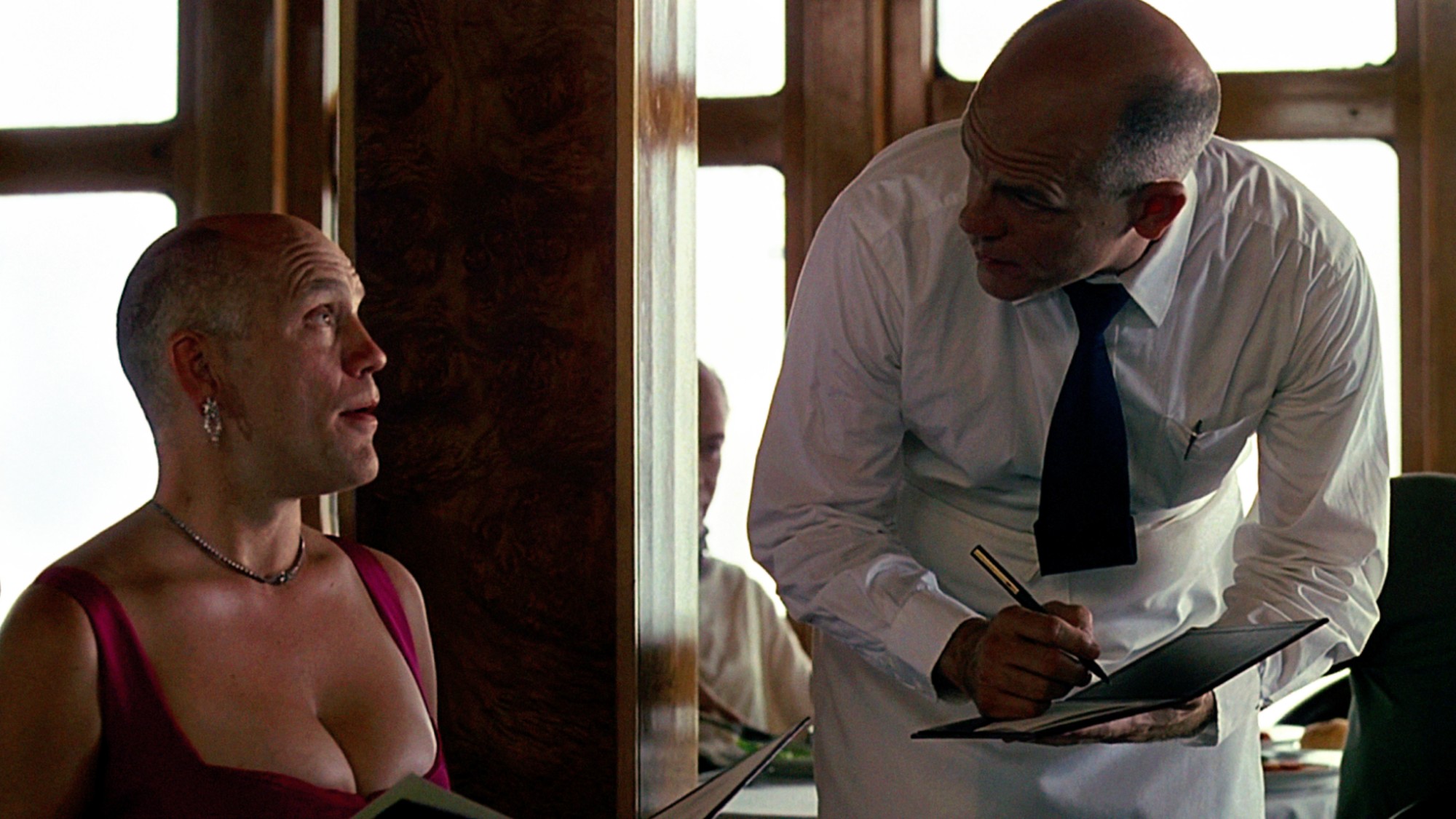 John Malkovich seen as a waiter and a woman ordering food at a restaurant in Being John Malkovich