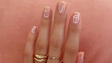 Womans hands with the word love written on them - valentines nails