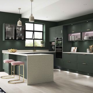 kitchen with dark green wall and marble worktop with wooden flooring