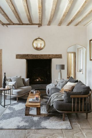 rustic living room with open fire and sofas