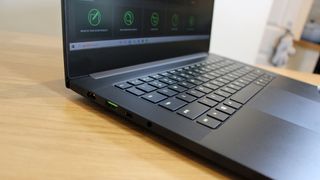 Image is a side view of an open Razer Blade 14.