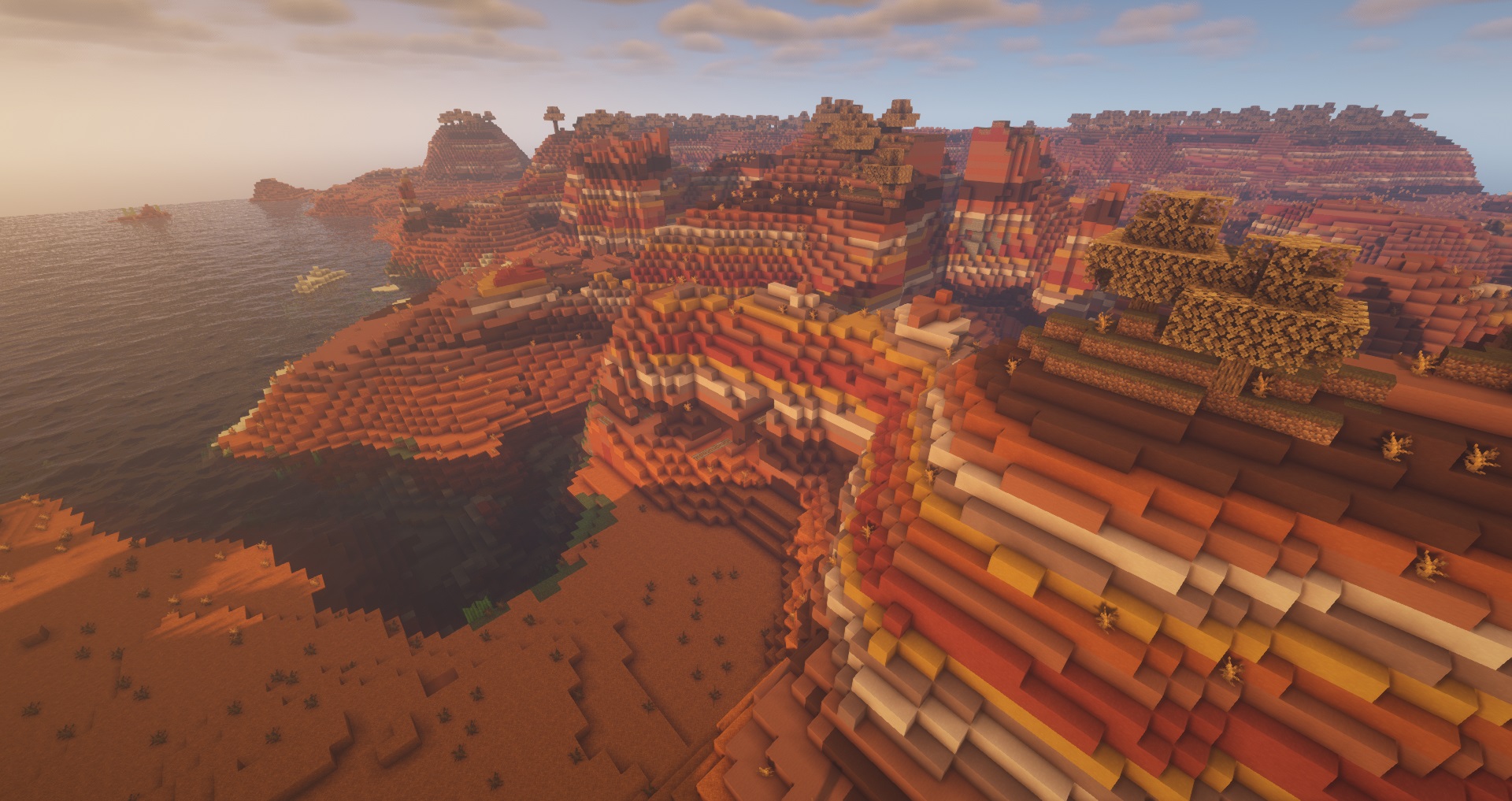 Minecraft seeds - Badlands - A mesa badlands biome full of clay mountains with a small exposed mineshaft visible at the base