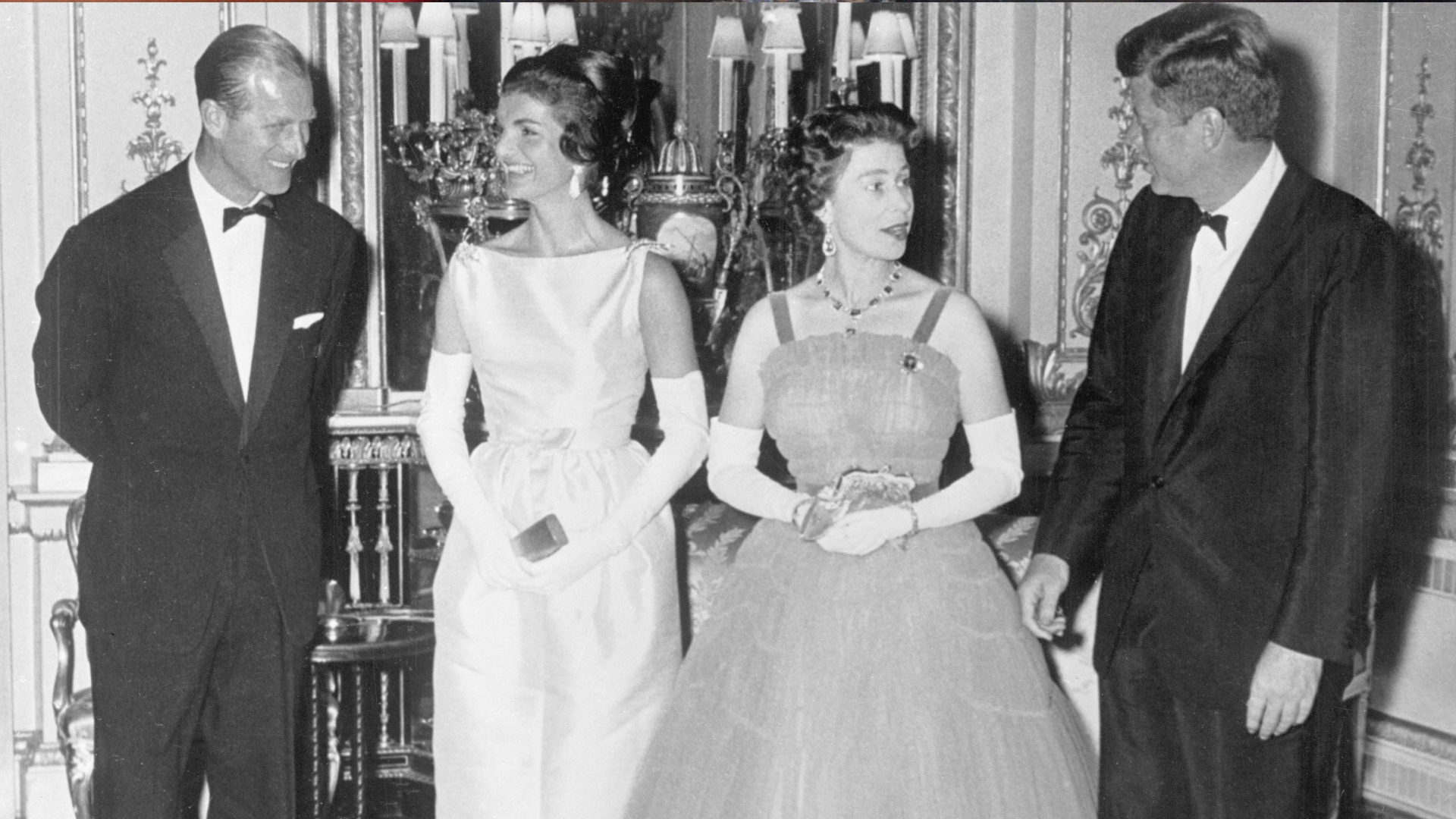 Prince Philip, Jackie Kennedy, Queen Elizabeth and John F. Kennedy dressed in formal wear at a Buckingham Palace dinner in 1961