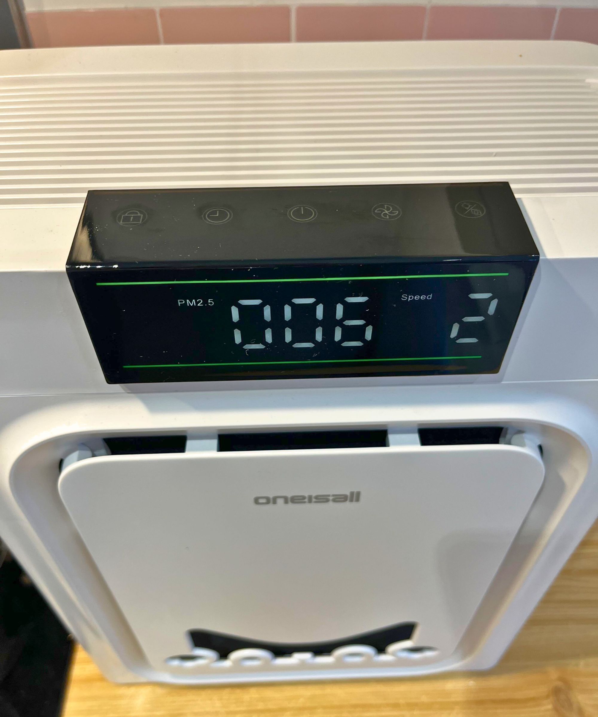 A closeup of the oneisall air purifier for pet hair and dander's digital touch screen. It shows 006 parts per million, speed of 2, and touch buttons for function lock, timer, power, speed and lights off mode.