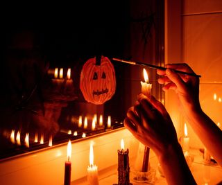 Painting pumpkin on a window