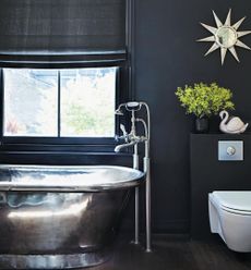 bathroom with black paint wall and steel bathtub